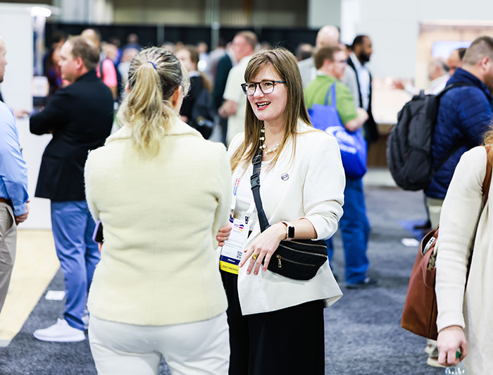 two conference attendees networking in exhibit hall